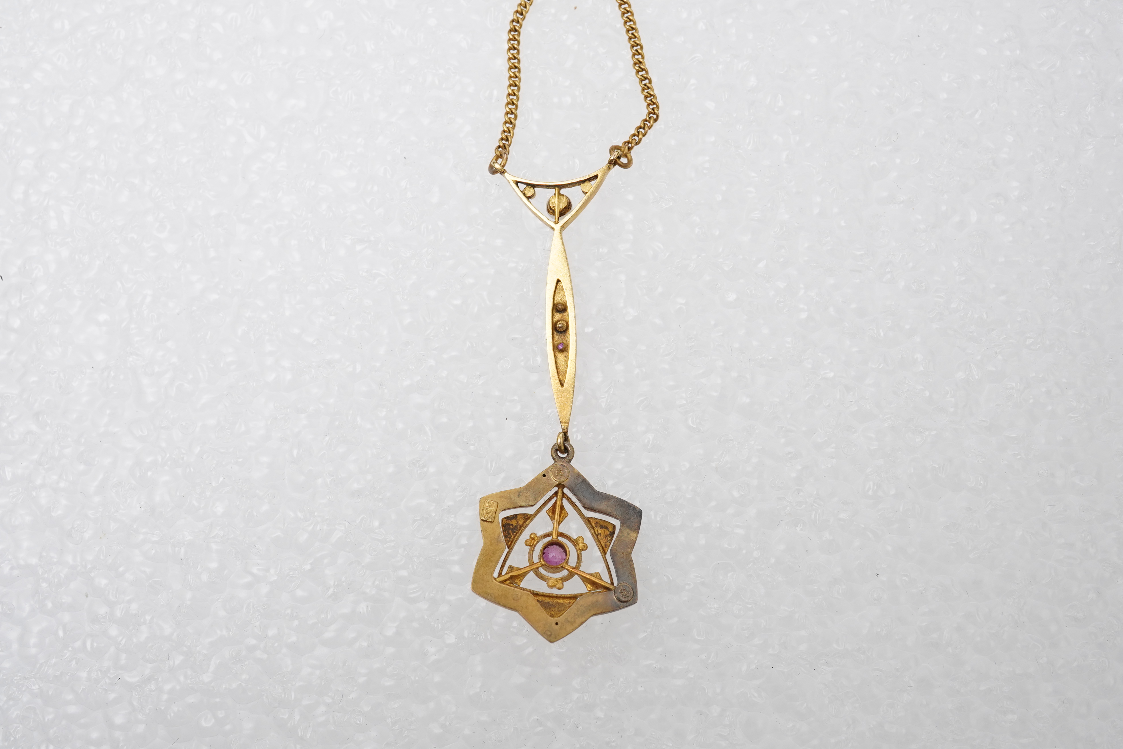 A gold, ruby and seed pearl pendant necklace, early 20th century